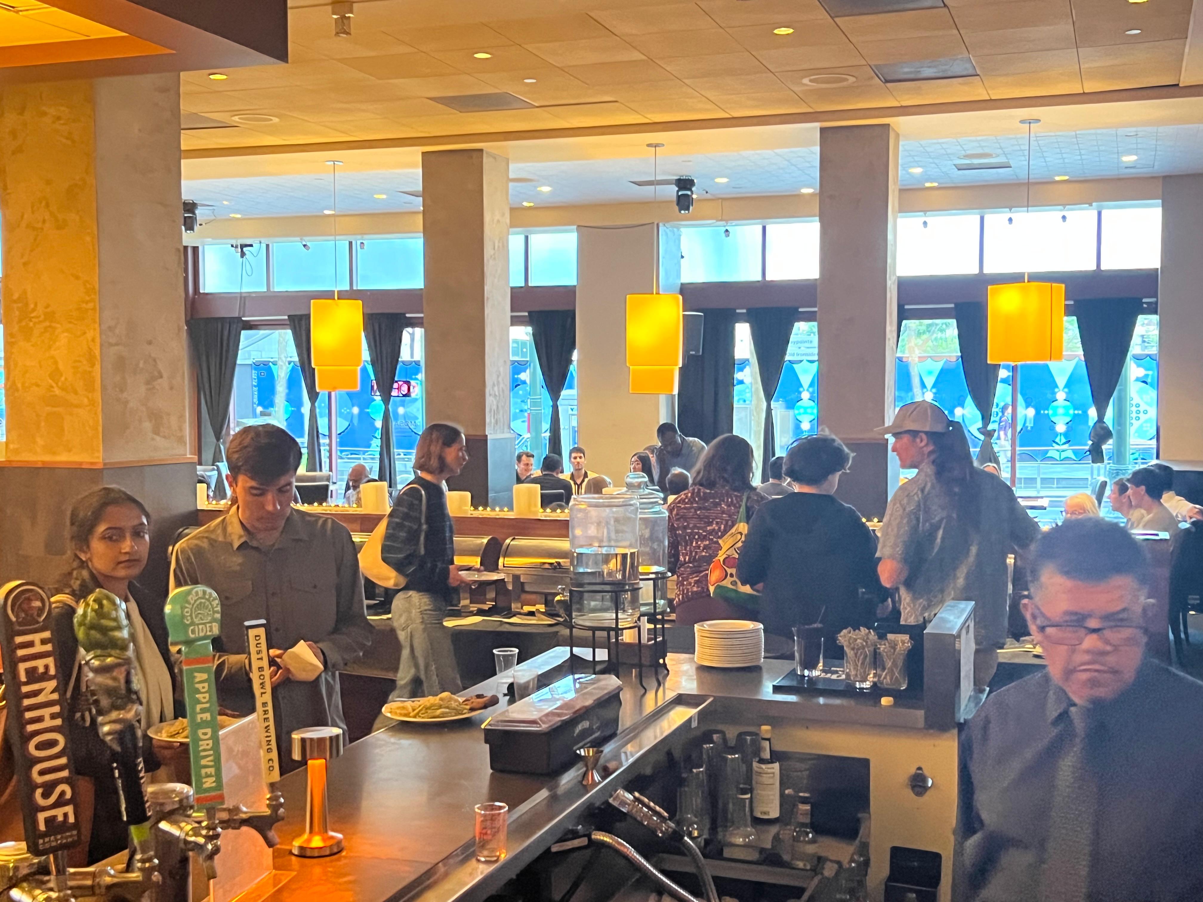 Guests gathered at the bar under warm lantern lighting